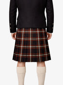 Person wearing a black jacket and plaid kilt  on a white background