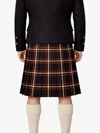 Person wearing a black jacket and plaid kilt  on a white background
