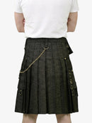 Person wearing a dark gray kilt with gold chain on a white background
