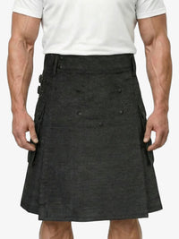 Person wearing a black kilt on a plain background