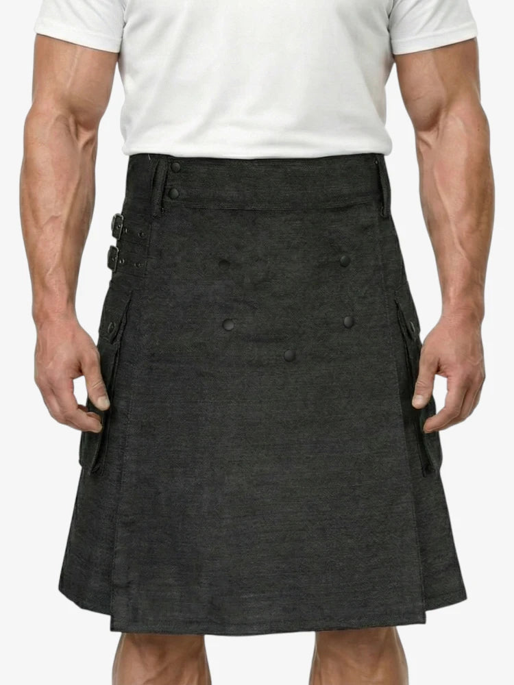 Person wearing a black kilt on a plain background