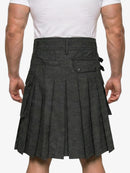 Person wearing a gray pleated kilt on a white background
