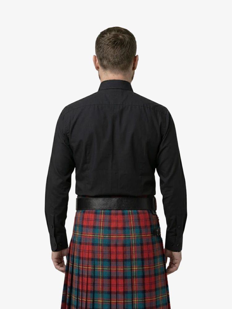 Man wearing a black shirt and red plaid kilt on a white background
