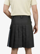 Person wearing a black pleated skirt with a plain background