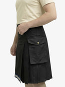 Black cargo kilt worn by a person on a white background