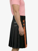 Black pleated skirt with orange stripe and decorative buttons on a white background