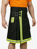 Black kilt with reflective yellow trim worn by a person in an orange shirt.