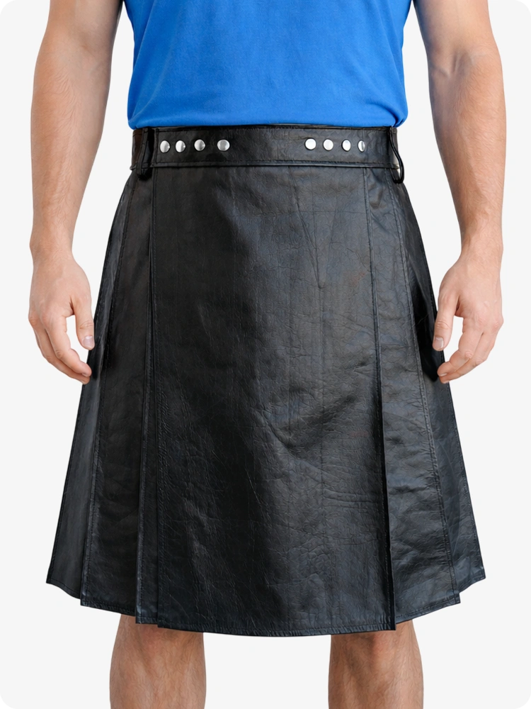 Person wearing a black leather kilt with a blue shirt on a white background