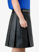 Black pleated skirt worn by a person with a blue top on a white background