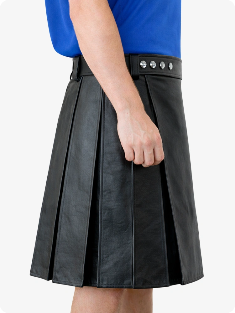 Black pleated skirt worn by a person with a blue top on a white background