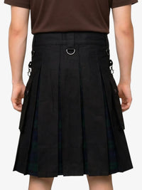 Person wearing a black pleated skirt with brown top on a white background
