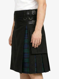 Black kilt with plaid lining worn by a person on a white background