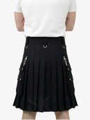 Person wearing a black pleated skirt with silver accents on a white background