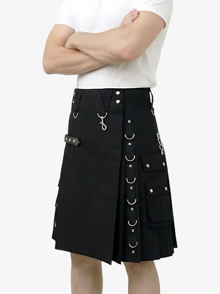 Black kilt with silver buttons and rings worn by a person on a white background