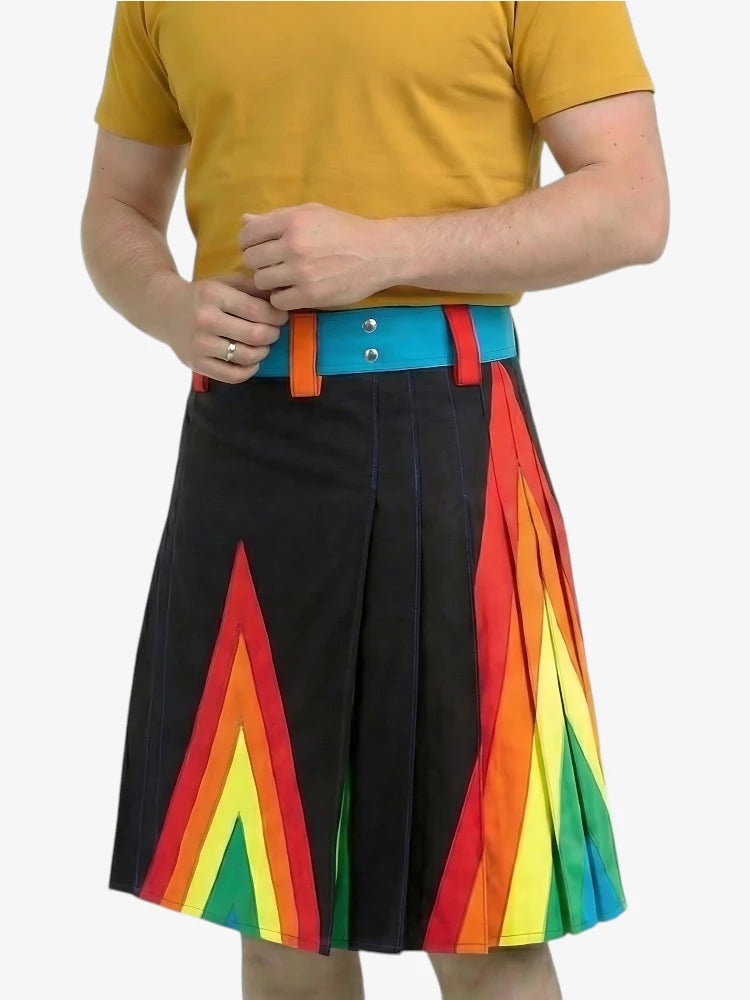 Person wearing a yellow shirt and a black skirt with rainbow patterns on a white background