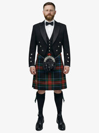 Man wearing a traditional Scottish black stewart tartan kilt with a black prince charlie jacket on a white background