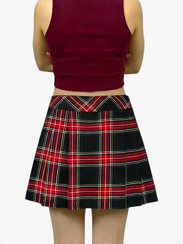 Person wearing a red plaid skirt and burgundy top on a white background