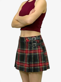 Person wearing a red plaid skirt with black belt on a white background