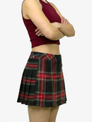 Person wearing a maroon tank top and plaid skirt on a white background