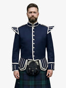 Man wearing a navy blue doublet jacket with white accents and a black watch tartan kilt on a white background
