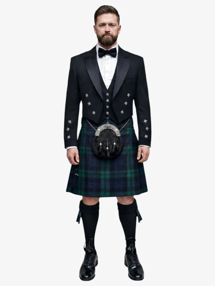 Man wearing a traditional Scottish black watch tartan kilt with a black prince charlie jacket on a white background
