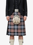 Person wearing a traditional Scottish kilt with a sporran on a white background