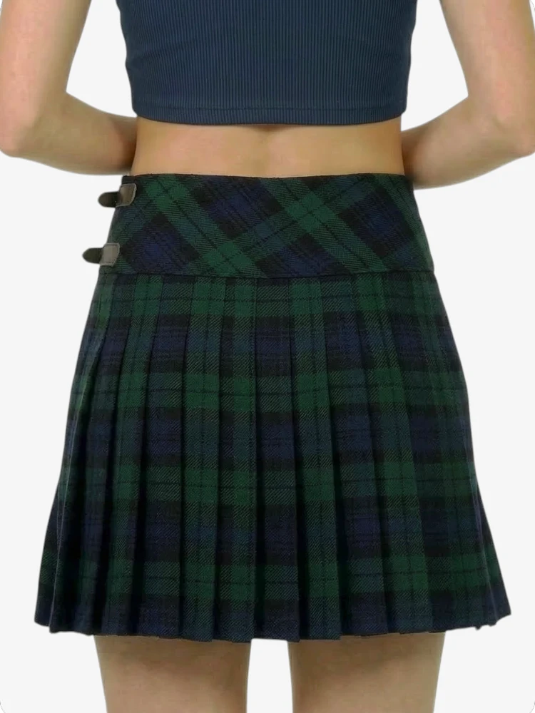 Green plaid skirt worn by a person on a white background