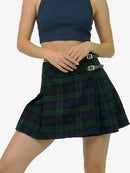 Person wearing a green plaid skirt on a white background