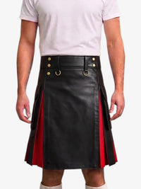 A man wearing a black faux-leather kilt with red side panels and gold-tone hardware, paired with a white t-shirt against a light gray background.