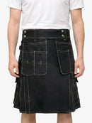 Person wearing a black kilt with white accents on a plain background