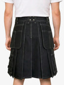 Black kilt worn by a person on a white background