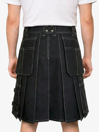 Black kilt worn by a person on a white background
