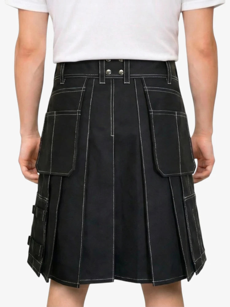 Black kilt worn by a person on a white background