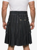 Person wearing a black pleated kilt on a white background