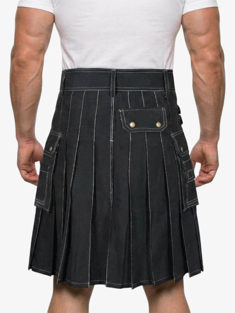 Person wearing a black pleated kilt on a white background
