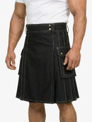 Black kilt worn by a person on a white background