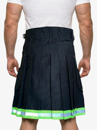 Person wearing a black pleated kilt with green trim on a white background