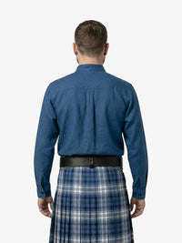 Man wearing a blue shirt and plaid kilt on a white background