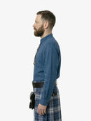 Man wearing a blue shirt and plaid kilt on a white background