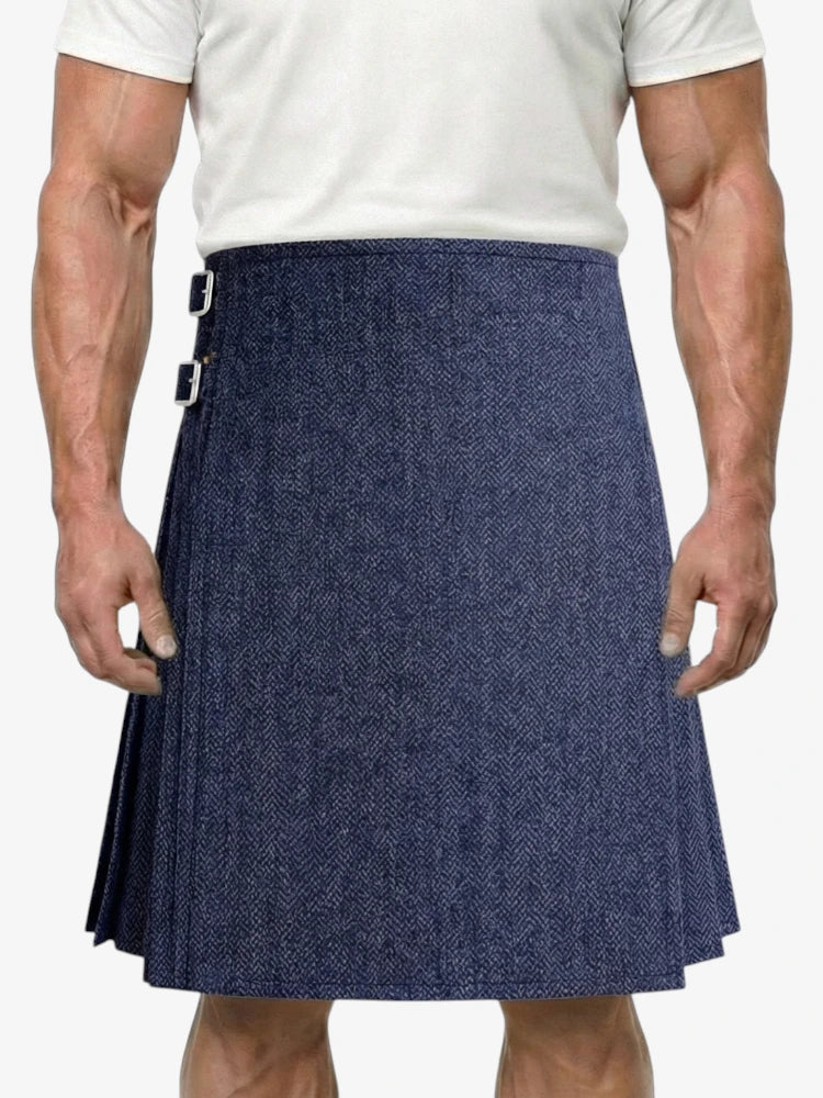 Man wearing a blue kilt on a white background
