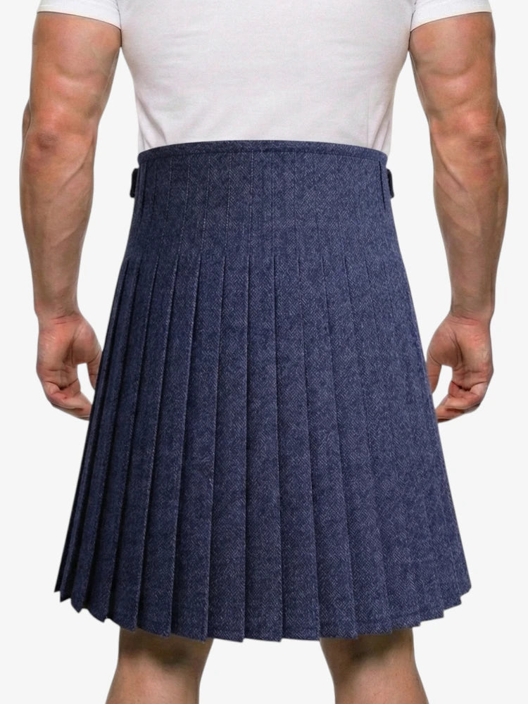 Person wearing a navy pleated kilt on a white background