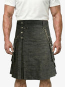 Person wearing a black kilt with silver buttons and chain on a white background