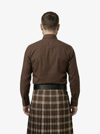 Man wearing a brown shirt and plaid kilt on a white background