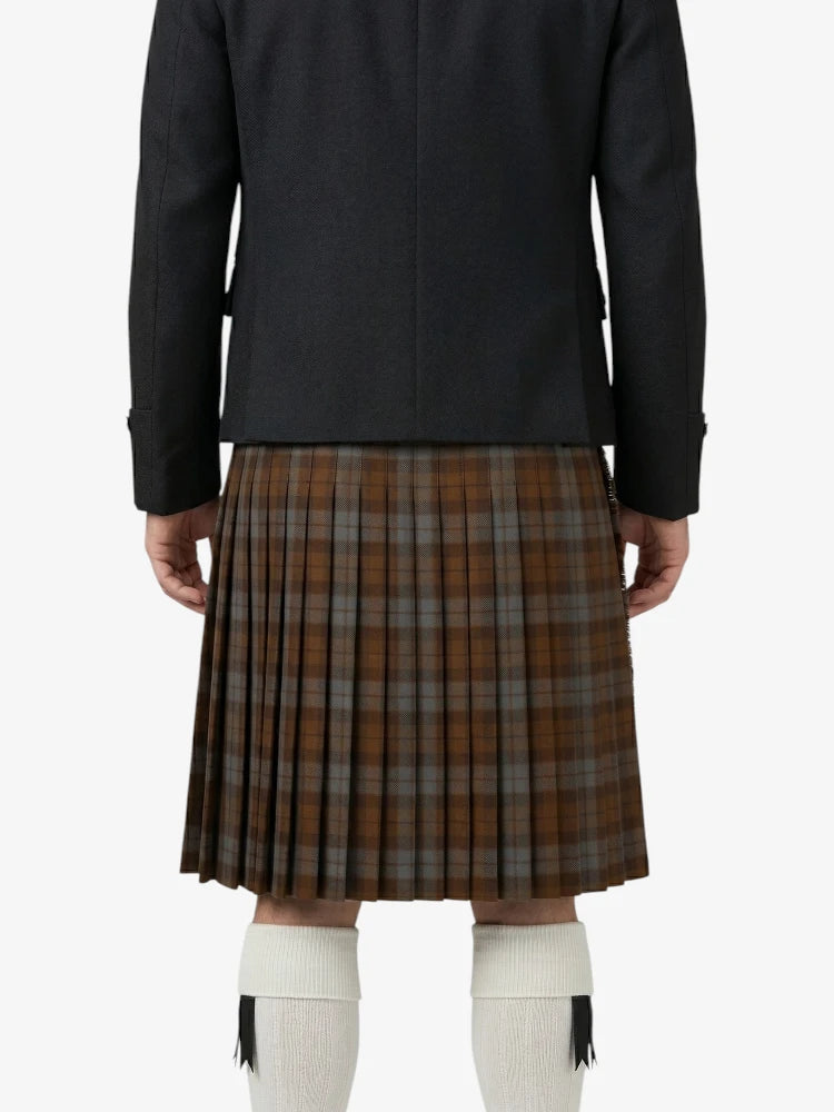 Person wearing a black jacket and brown plaid kilt on a white background