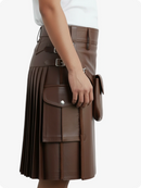 Brown pleated kilt with a hand holding a matching bag on a white background