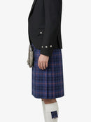 Person wearing a black jacket and blue plaid kilt on a white background