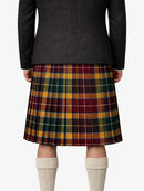 Person wearing a black jacket and plaid kilt on a white background