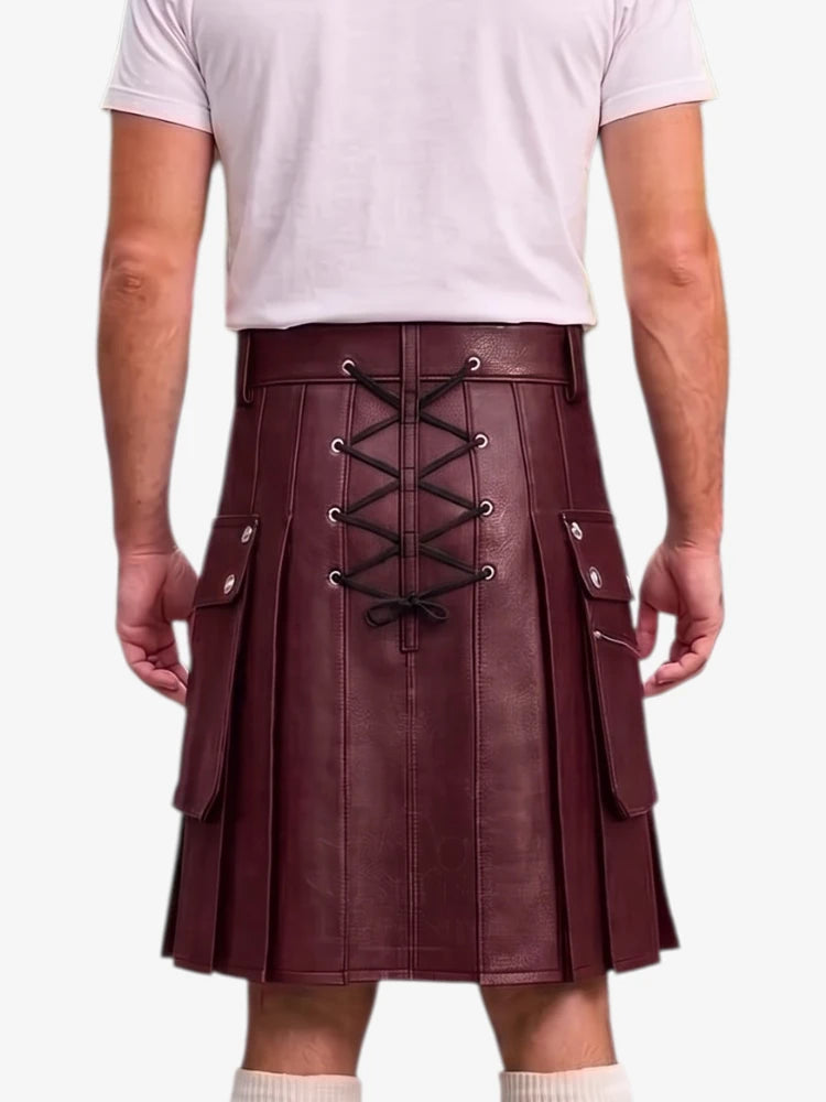 A person shown from the back wearing a pleated burgundy leather kilt with black lace-up detailing and silver-tone hardware, paired with a light pink t-shirt and white socks against a plain white background.