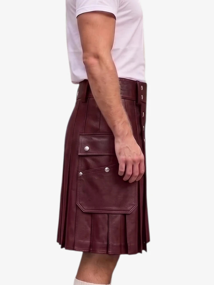 A side view of a person wearing a dark burgundy faux-leather kilt with silver snap buttons and flap pockets, paired with a white t-shirt, against a plain white background.