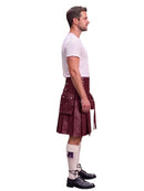 A man shown in profile wearing a dark red leather kilt, a white t-shirt, white knee-high socks, and black leather shoes, set against a plain white background.